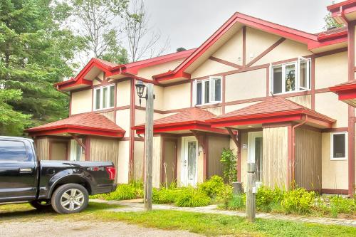 a black truck parked in front of a house at Mont-Tremblant in Mont-Tremblant