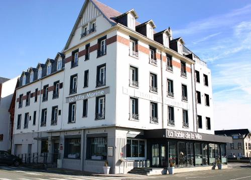 a large white building on the corner of a street at The Originals Boutique, Hôtel La Villa Marine, Le Tréport in Le Tréport