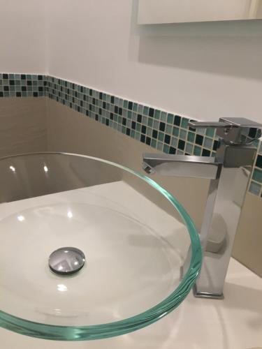 a bathroom with a sink with a water faucet at B&B La Rada in Sorrento