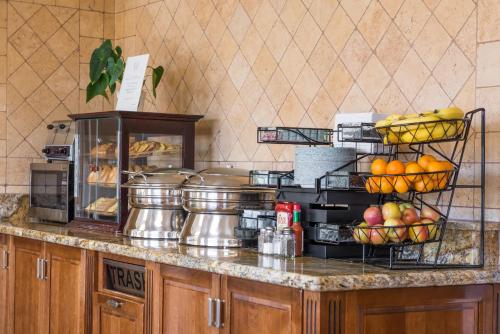 a kitchen counter with fruit in baskets on it at Laurel Inn & Conference Center in Salinas