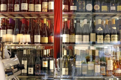 a bunch of bottles of wine on display in a store at Hôtel Alchimy in Albi