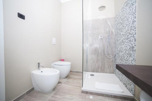 a bathroom with a shower and a toilet and a sink at Trevi Portrait in Rome