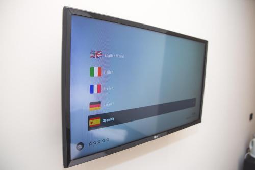 a flat screen tv hanging on a wall at Trevi Portrait in Rome