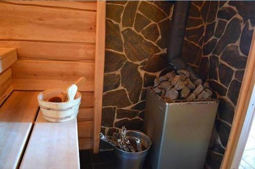 a room with a stove and a stone wall at Borowinowy Zdrój Hotel Wellness Spa & Conference in Supraśl