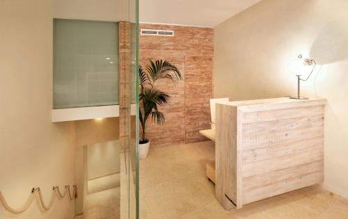 a bathroom with a glass shower with a plant in it at Laqua by the Sea in Meta