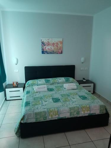 a bed in a bedroom with a blue wall at Hotel Daisy in San Giovanni Lupatoto
