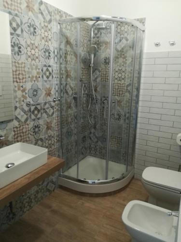 a bathroom with a shower and a toilet and a sink at Casa Malo' in Ischia