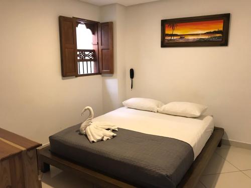 Postel nebo postele na pokoji v ubytování Hotel Bahia Guatape