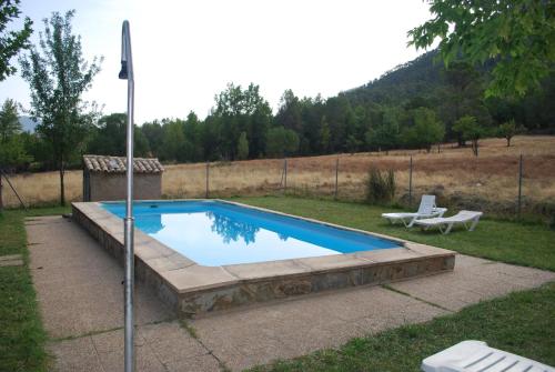 a swimming pool in a yard with a bench at Capellania 2 in Arroyo Frio
