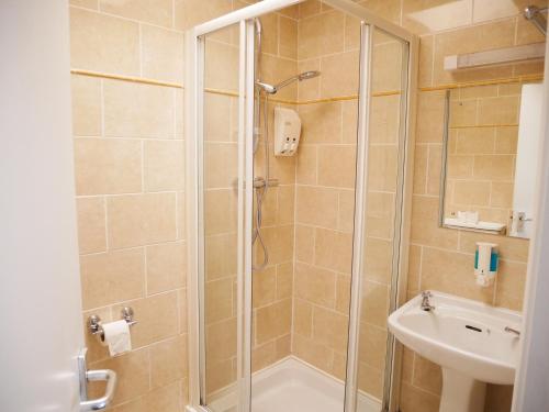 a bathroom with a shower and a sink at Townhouse Tullamore in Tullamore