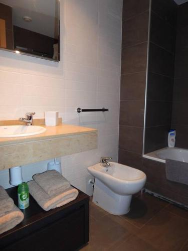 a bathroom with a sink and a toilet at Masia Blanca - Coma-ruga in Comarruga