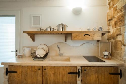 a kitchen with a sink and a counter at Casa Regina Paola in Monopoli