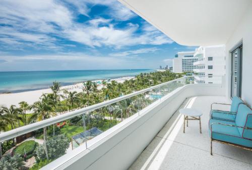 a balcony with a blue chair and a view of the beach at Faena Hotel Miami Beach in Miami Beach