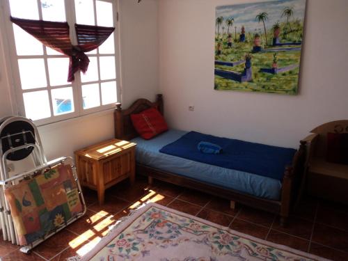 a small bedroom with a bed and a window at Joli appartement au terrasse pour 3 personnes in Essaouira