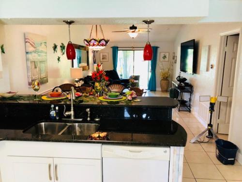 a kitchen with a sink and a living room at 2 Bedroom , 2 Bath , Villa in Oldsmar