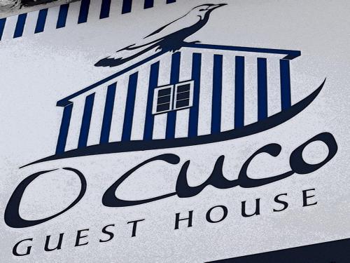 a bird sitting on top of a west house sign at GuestHouse O Cuco in Praia de Mira