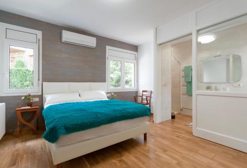 a bedroom with a bed with a blue blanket at El jardí de l'avet in Lleida