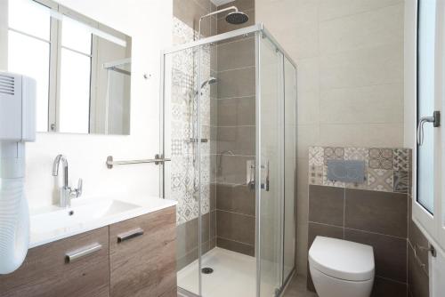 a bathroom with a shower and a toilet and a sink at Les cles du 27 Paris in Paris