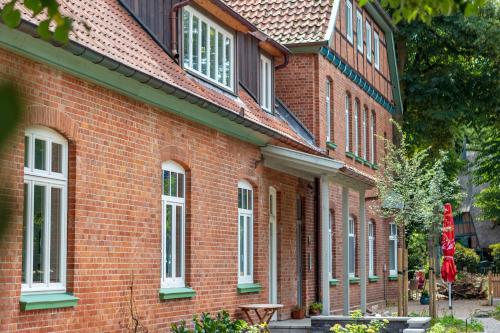 a red brick building with a bench in front of it at Gästezimmer St. Dionys in Sankt Dionys