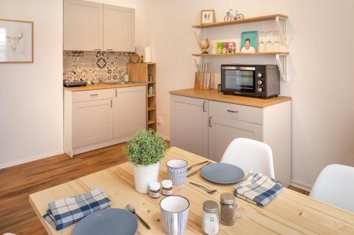 a kitchen with a wooden table with a microwave at TOP-Lage, 400 m bis GOP, Bali-Therme und Kurpark - HDZ - Parkplatz in Bad Oeynhausen