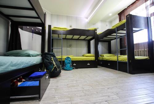 a room with three bunk beds in it at Apple Hostel Bishkek in Bishkek