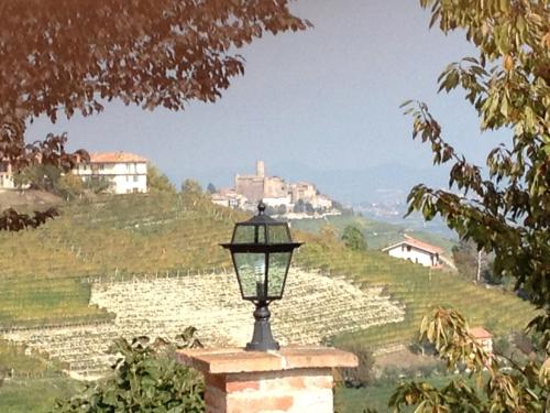 a street light in front of a field of crops at Palazzo d'Assi - Guest house in Monforte dʼAlba