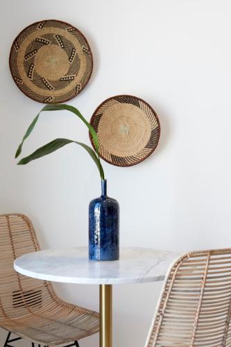 a blue vase sitting on a table with two chairs at Phos The Boutique in Akrotiri