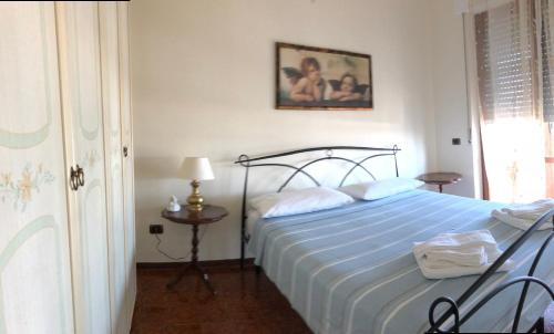 a bedroom with a bed with a blue comforter at B&B La Finestra sui Trabocchi in San Vito Chietino