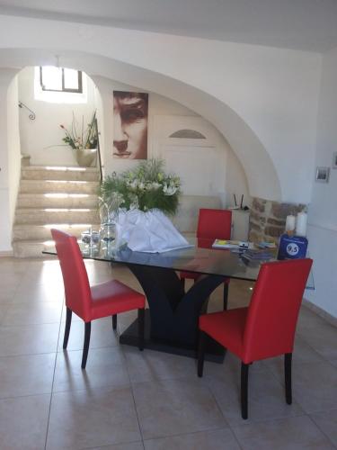 a dining room with a table and red chairs at Il Palazzetto dei Briganti in Guardiaregia