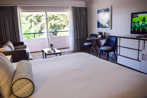 a hotel room with a large bed and a tv at Beachside Inn in Santa Barbara