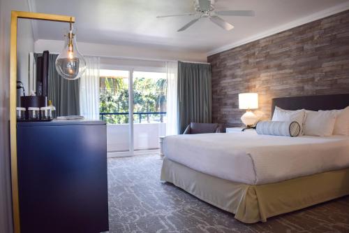 a bedroom with a large bed and a window at Beachside Inn in Santa Barbara