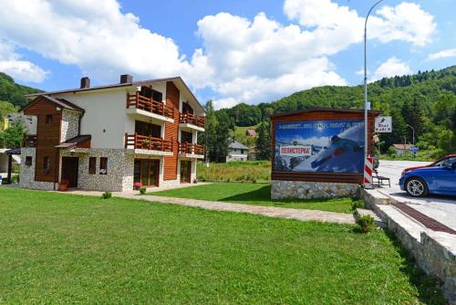 a building with a large billboard in front of it at Villa 'Iva' in Mavrovo