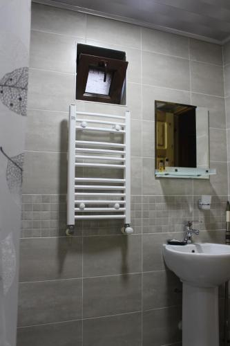 a bathroom with a sink and a mirror at Guest House on Meskheti in Borjomi