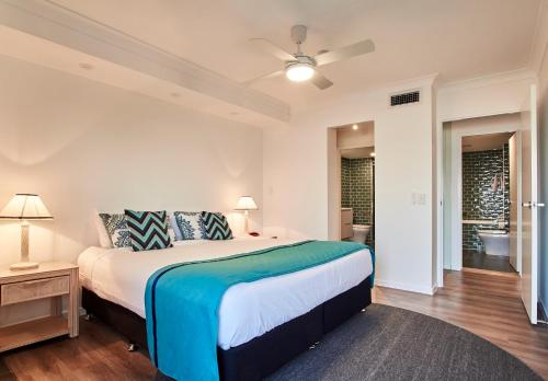 a bedroom with a large bed and a bathroom at Albatross North Apartments in Gold Coast