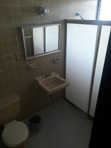 a bathroom with a toilet and a sink at Hotel Maria Luisa in Iguala de la Independencia