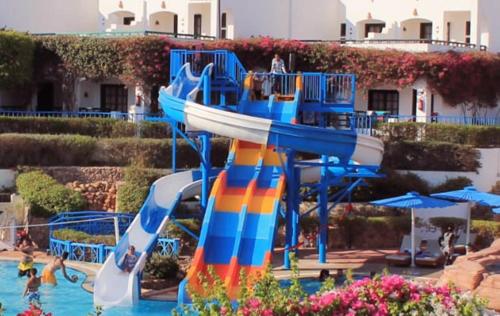 a water slide in a water park with people on it at Verginia Sharm Resort & Aqua Park in Sharm El Sheikh