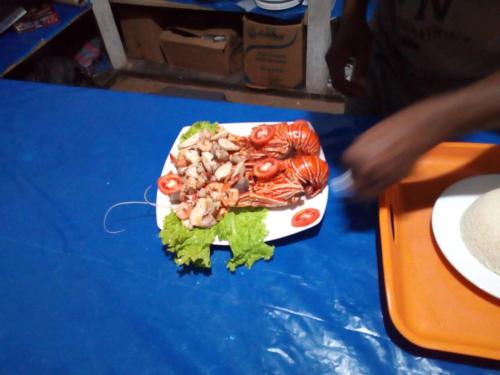 a plate of food on top of a table at Dolphin Village in Kalpitiya