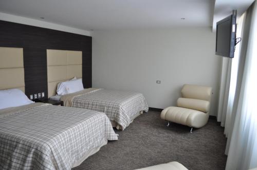 Ένα ή περισσότερα κρεβάτια σε δωμάτιο στο Hotel Astor