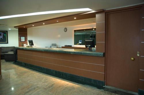 a lobby of a hospital with a reception counter at Hotel Astor in Mexico City