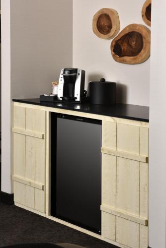 a kitchen counter with a black appliance on top of it at Stoney Creek Hotel Tulsa - Broken Arrow in Broken Arrow