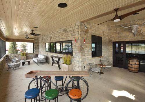 a group of bikes parked next to a table and chairs at Stoney Creek Hotel Tulsa - Broken Arrow in Broken Arrow