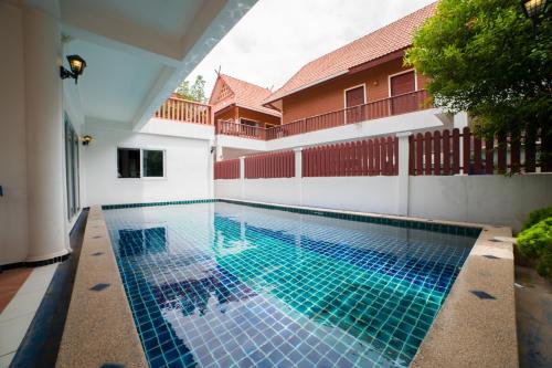 a swimming pool in the middle of a house at Naiyang Beach Private Pool Villa in Nai Yang Beach