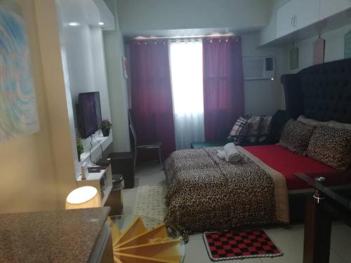a small bedroom with a bed and a window at Nica's Place Property Management Services at Horizons 101 Condominium in Cebu City