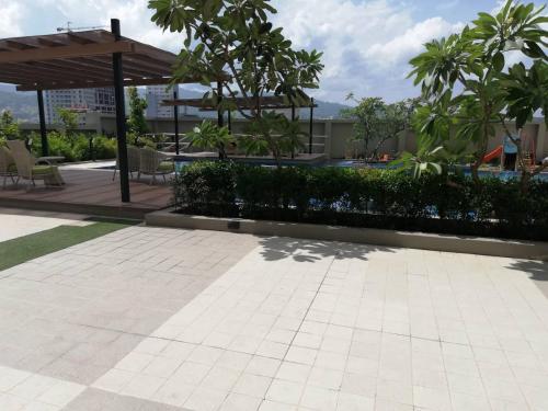 a patio with a table and chairs and trees at Nica's Place Property Management Services at Horizons 101 Condominium in Cebu City