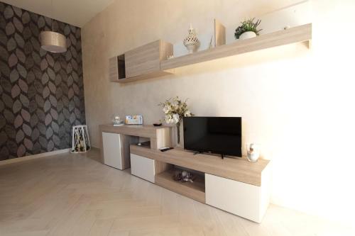 a living room with a flat screen tv on a wall at Tommy's Apartment in Pompei