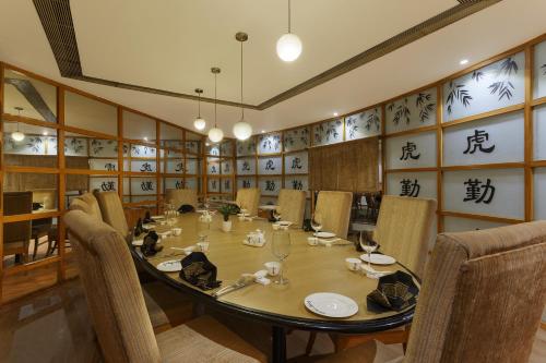 a large dining room with a large table and chairs at Park Plaza, Ludhiana in Ludhiana