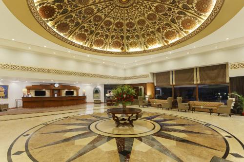 a lobby with a large ceiling with a fountain at Park Plaza, Ludhiana in Ludhiana