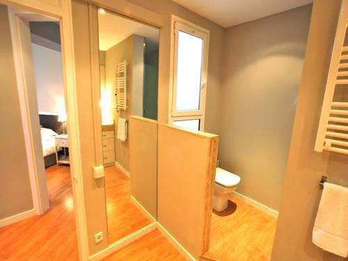 a bathroom with a toilet and a window at 555 Apartments BCN in Barcelona