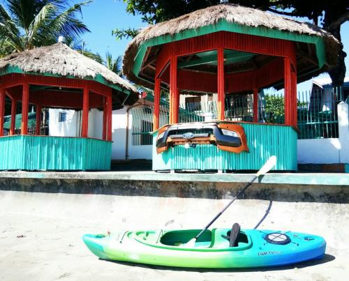 a blue kayak on the sand in front of a building at SmallFry's Beach Resort in Calatrava