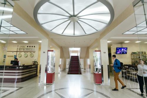 people are walking through the lobby of an airport at Bukovyna Hotel in Chernivtsi